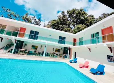 a villa with a swimming pool in front of a house at El Paso Hotel in Arroyo de Agua