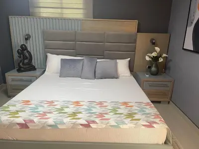 a bedroom with a large bed with a quilt on it at El Paso Hotel in Arroyo de Agua