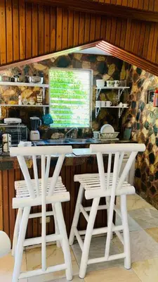 a white table and two white chairs in a kitchen at Villa Marcia in Boca Chica