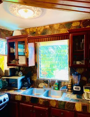 a kitchen with a sink and a window at Villa Marcia in Boca Chica