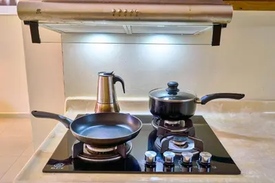 a pot on a stove with a tea kettle on it at Hotel Libertad at historic main street in Santo Domingo
