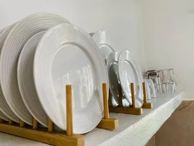 a row of white plates on a shelf at Casa Blanca - White House in Cabarete