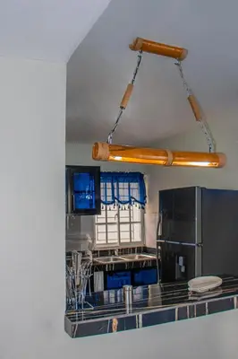 a kitchen with blue cabinets and a stainless steel refrigerator at D' Yoko Village's in Pedernales