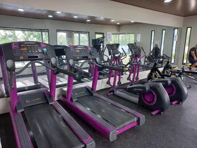 a gym with several tread machines and people in the background at Las vacaciones que soñaste en un lugar seguro! in Santiago de los Caballeros