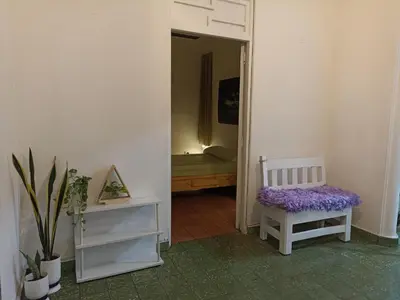 a white room with a chair and a mirror at La casa de Isabel y Juan, Zona Colonial in Santo Domingo