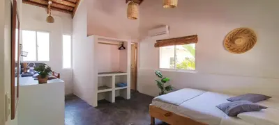 a bedroom with a bed and a sink and a window at Kite House Cabarete across Kite Beach in Cabarete