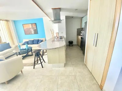 a kitchen and living room with a table and a couch at 703 Marbella 2 bedrooms Beachfront Beautiful Apartment in San Pedro de Macorís