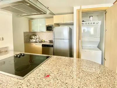 a kitchen with a granite counter top and a refrigerator at 703 Marbella 2 bedrooms Beachfront Beautiful Apartment in San Pedro de Macorís