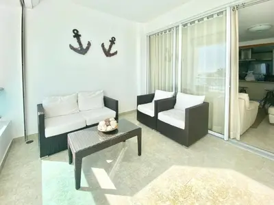 a living room with a couch and a table at 703 Marbella 2 bedrooms Beachfront Beautiful Apartment in San Pedro de Macorís