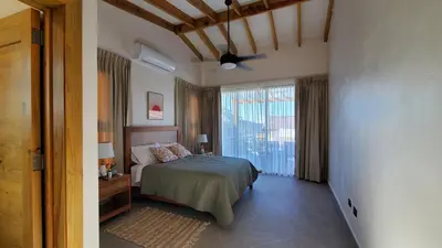 a bedroom with a bed and a large window at Villa en la montaña in Jarabacoa