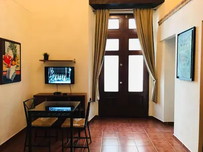 a room with a door and a table and a desk at Paseo Colonial - Sabbatical #1 in Santo Domingo