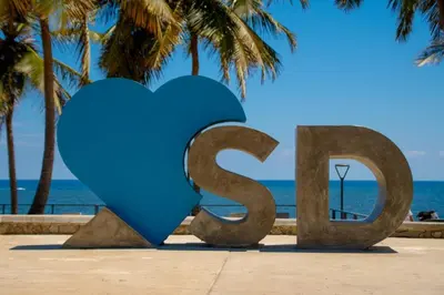 a heart sculpture on the beach with palm trees at Hotel Conquistador Santo Domingo in Santo Domingo