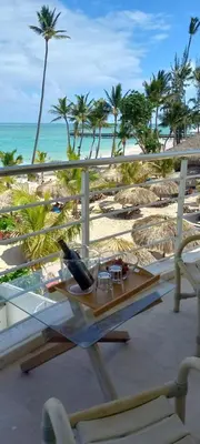 a balcony with a table and chairs and the beach at Private room overlooking the beach in Punta Cana
