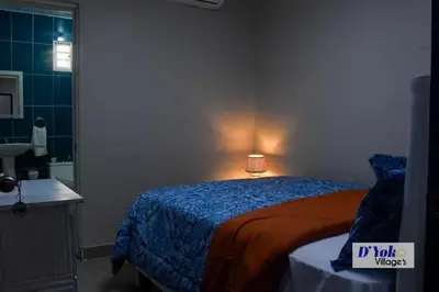 a bedroom with a bed with a lamp on it at D´ Yoko Village´s in Pedernales