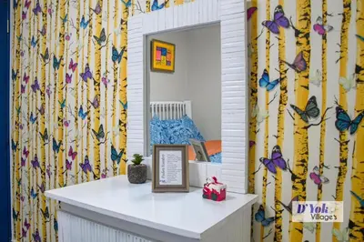 a mirror in a room with butterflies on the wall at D´ Yoko Village´s in Pedernales