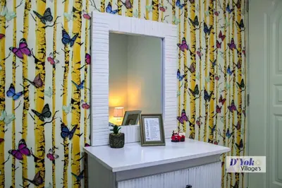 a mirror in a room with butterflies on the wall at D´ Yoko Village´s in Pedernales
