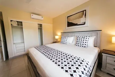 a bedroom with a large white bed with pillows at Special Offer, Iberostar Apartment Milagro 3BDR Pool, Beach in Punta Cana