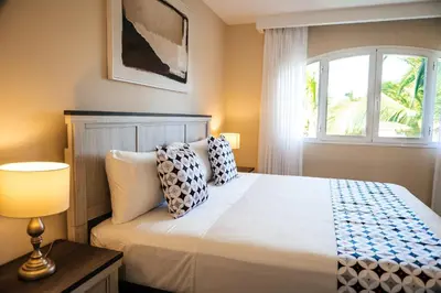 a bedroom with a large bed with a window at Special Offer, Iberostar Apartment Milagro 3BDR Pool, Beach in Punta Cana