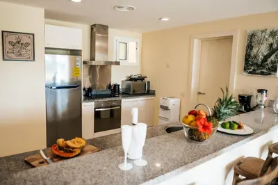 a kitchen with a counter with a bowl of fruit on it at Spacious Iberosta ApartmentSueno - 3BDR Pool, Beach, WiFi in Punta Cana