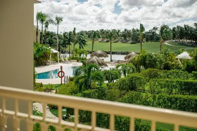 a view of the pool from the balcony of a resort at Spacious Iberosta ApartmentSueno - 3BDR Pool, Beach, WiFi in Punta Cana