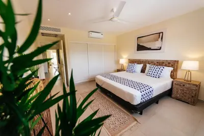 a bedroom with a bed and a plant at Spacious Iberosta ApartmentSueno - 3BDR Pool, Beach, WiFi in Punta Cana