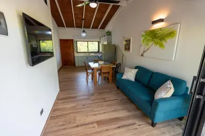 a living room with a blue couch and a table at Beach Apartment Villas Jubey, Emotion access in Juan Dolio
