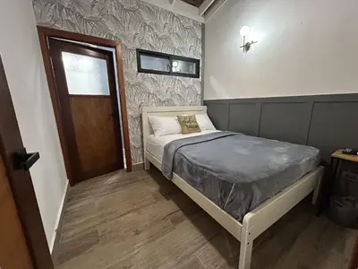 a small bedroom with a bed and a door at Beach Apartment Villas Jubey, Emotion access in Juan Dolio
