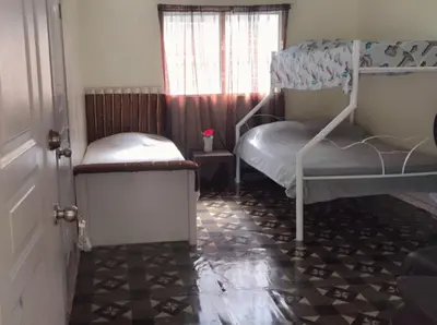 a bedroom with two bunk beds and a window at Hacienda de Flores in Guayacanes