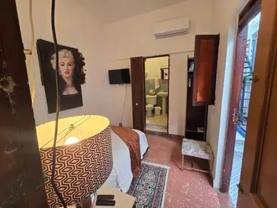 a living room with a table and a mirror at Colonial apartment for up to 4 person in Santo Domingo