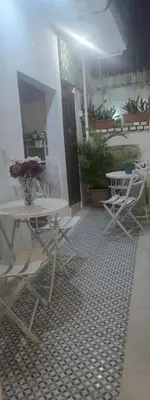 a patio with two tables and chairs on a floor at Colonial apartment for up to 4 person in Santo Domingo