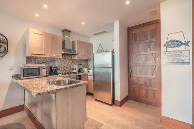 a kitchen with a stainless steel refrigerator and a sink at Wonderful Apt at Casa de Campo in El Infiernito