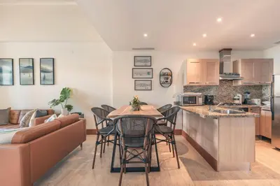 a kitchen and living room with a table and chairs at Wonderful Apt at Casa de Campo in El Infiernito
