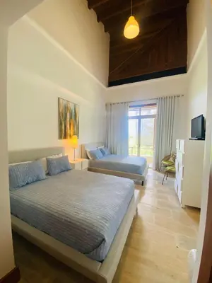 a bedroom with two beds and a television in it at Wonderful Apt at Casa de Campo in El Infiernito