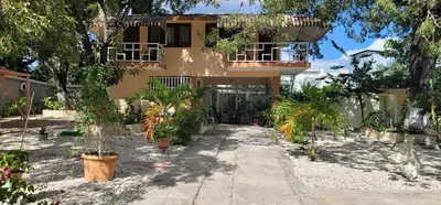 a house with a lot of plants in front of it at Casita de las flores in San José de Ocoa