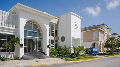 a white building on the side of a street at Golf & Lake View Oasis •Private Jacuzzi •Hard Rock in Punta Cana