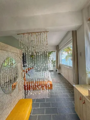 a room with a bunch of wine bottles hanging from a wall at Marina Bay in Las Terrenas