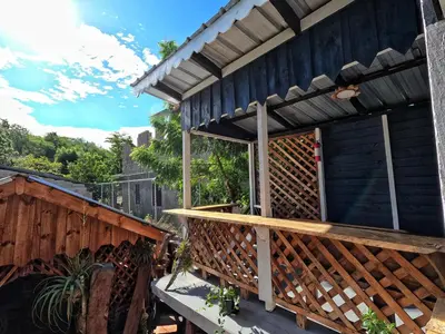 a porch of a house with a wooden railing at Rustic House Punta Rucia in Punta Rucia