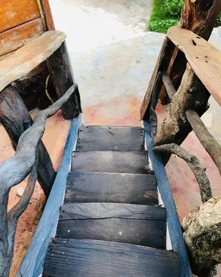 a wooden stairway leading up to a wooden bench at Rustic House Punta Rucia in Punta Rucia