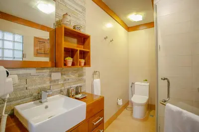 a bathroom with a sink and a toilet at Fontana di Rosa, African Style Villa Casa de Campo in La Romana