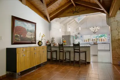 a kitchen with a table and chairs in a room at Fontana di Rosa, African Style Villa Casa de Campo in La Romana