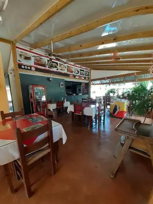 a dining room with tables and chairs in a restaurant at Habitación Hogareña in Jarabacoa