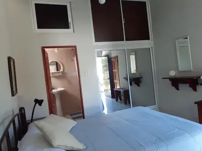a bedroom with a bed and a mirror at Habitación Hogareña in Jarabacoa