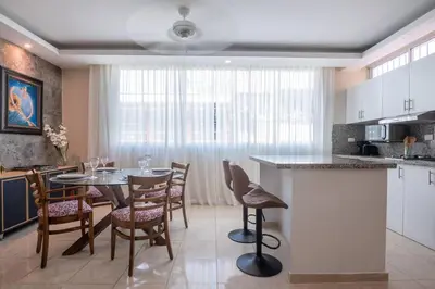 a kitchen and dining room with a table and chairs at Suite 10 en la Zona Colonial in Santo Domingo