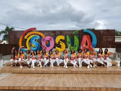 a group of women posing for a picture in front of a sign at Casa Linda beautiful Villa in Sosúa