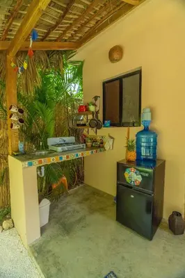 a room with a desk and a television in it at Casita Chinola - Playa El Encuentro in Bombita