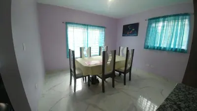a dining room with a table and chairs at Apartamento amueblado Res Blue Amber, 1 habitación in Santiago de los Caballeros