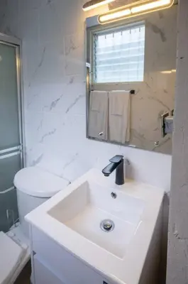 a white bathroom with a sink and a toilet at Cozy Suite 8 en la Zona Colonial in Santo Domingo