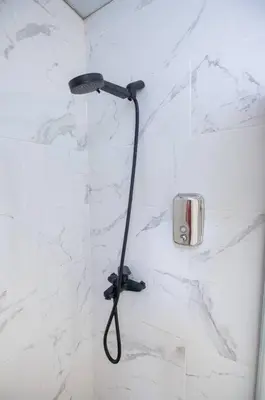 a shower with a black shower head in a bathroom at Cozy Suite 8 en la Zona Colonial in Santo Domingo