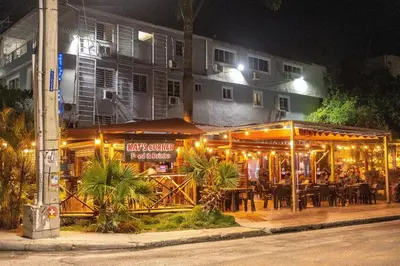 a restaurant with lights on a street at night at Private Pool View 2BDR in Los Corales Punta Cana in Punta Cana