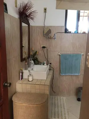 a bathroom with a sink and a mirror at Centerpice Colonial Zone in Santo Domingo